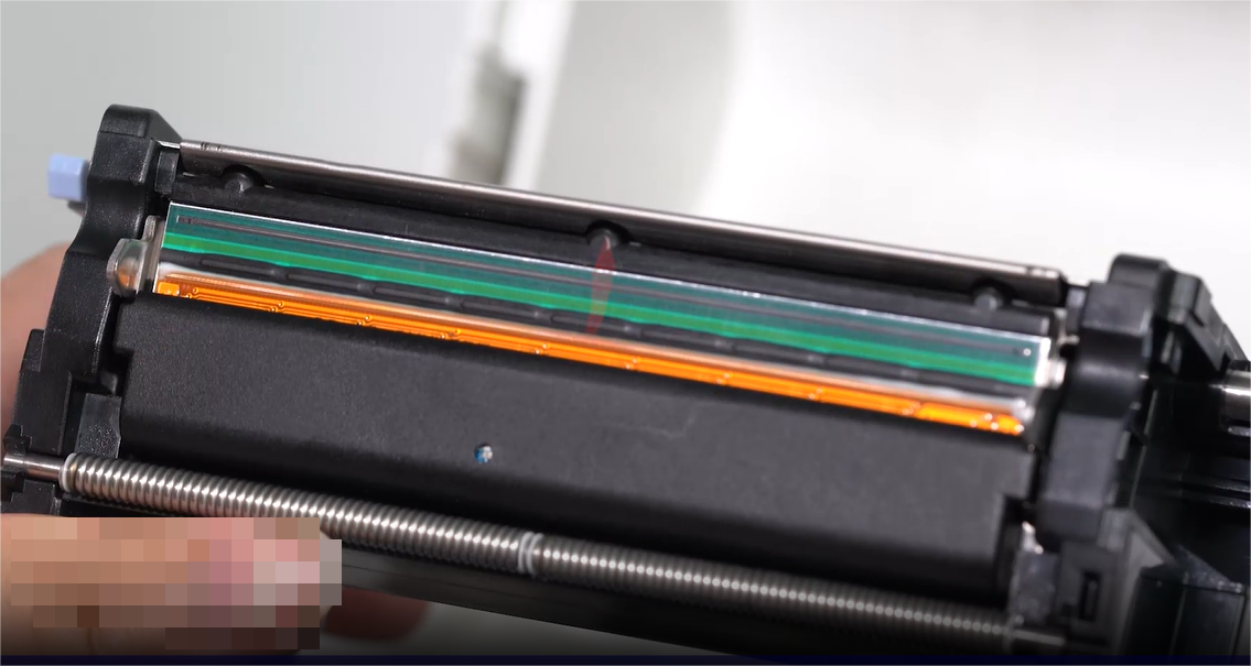 En close-up of a person carefully cleaning an electronic component with a swab.